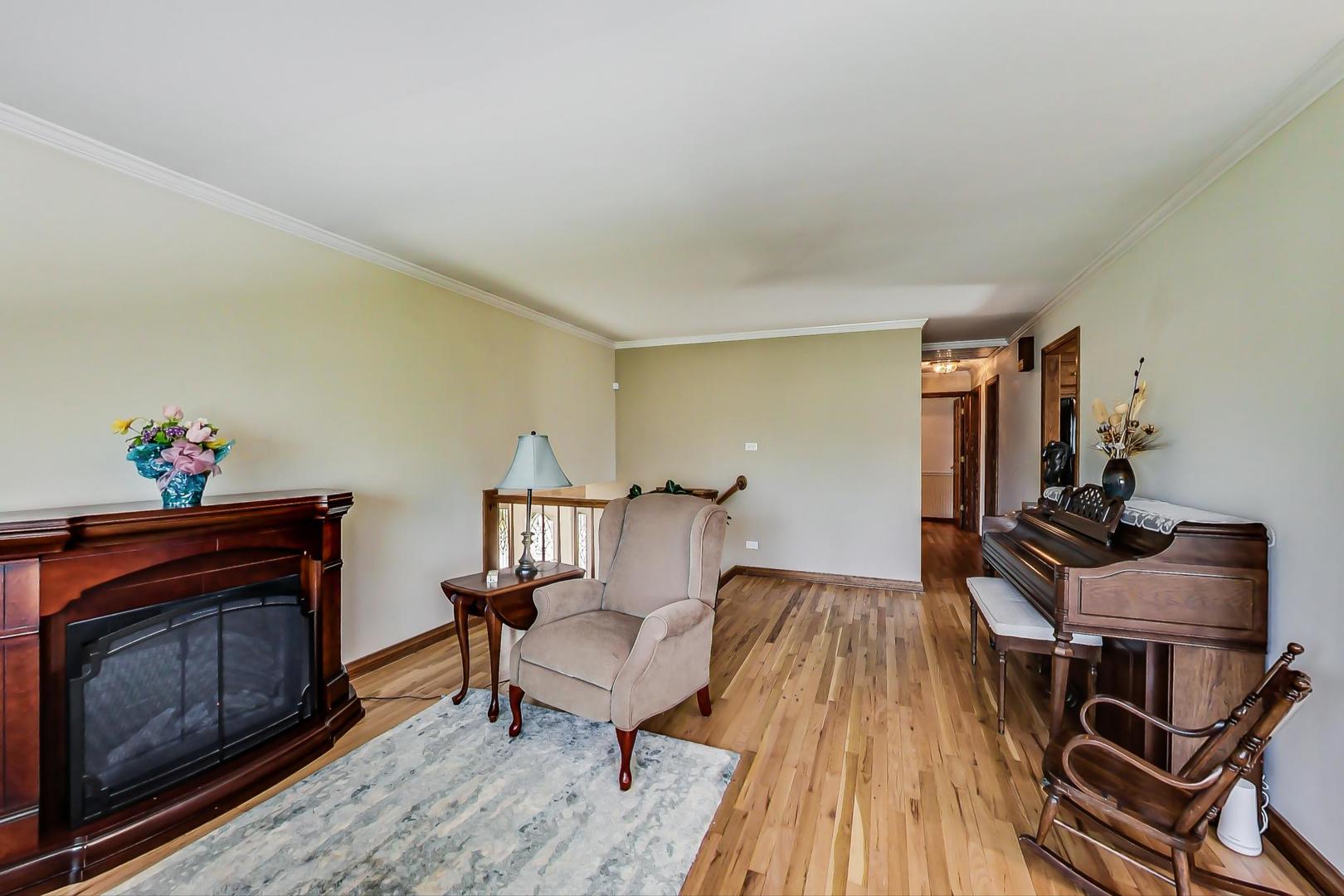 1715 Fremont Road Hoffman Estates, IL 60169 - Photo 8 of 59 a living room with furniture and a fireplace