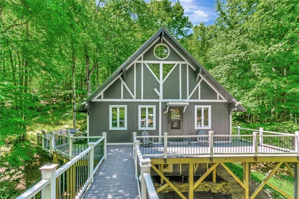 a house with tall trees in the background