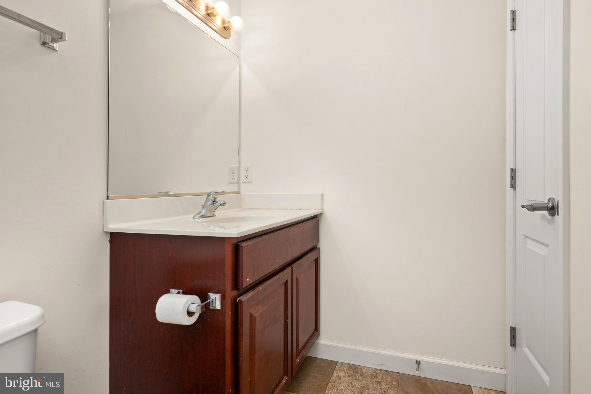 143 Medal Way Magnolia, DE 19962 - Photo 18 of 34 a bathroom with a sink and a mirror