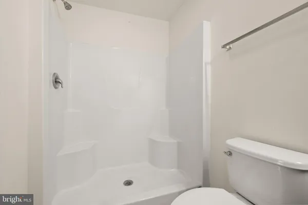 a bathroom with a shower and toilet