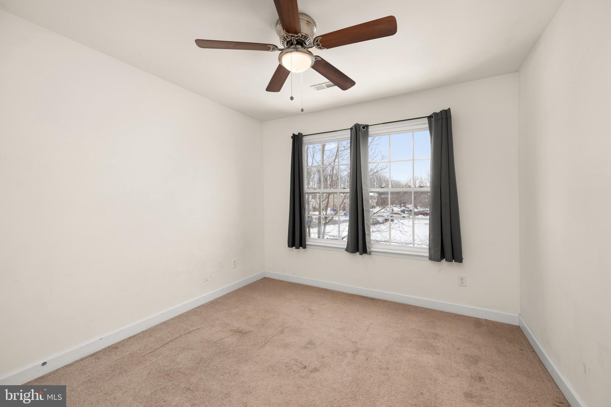 143 Medal Way Magnolia, DE 19962 - Photo 24 of 34 an empty room with windows and ceiling fan