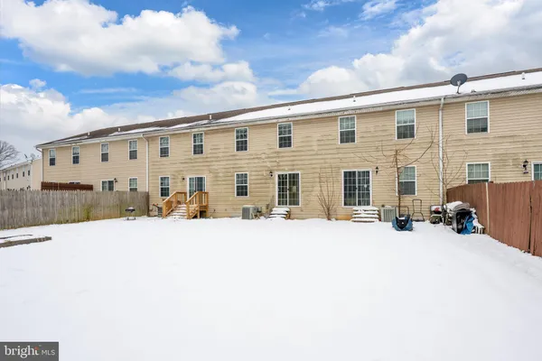 a front view of a building with cars parked in front of it