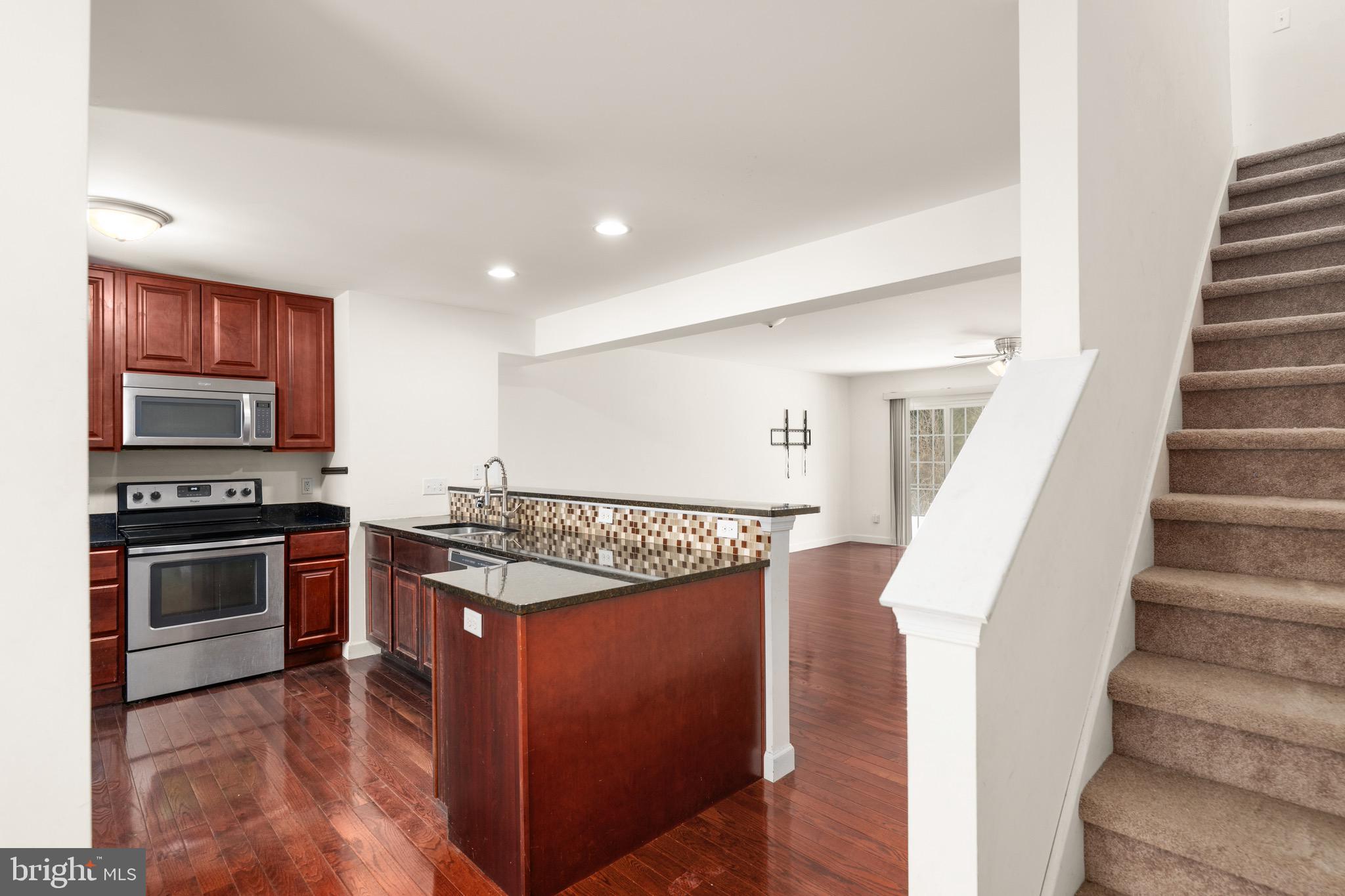 143 Medal Way Magnolia, DE 19962 - Photo 4 of 34 a open kitchen with stainless steel appliances granite countertop a stove and a refrigerator