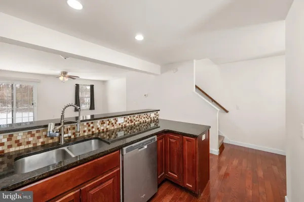 a kitchen with sink cabinets and wooden floor