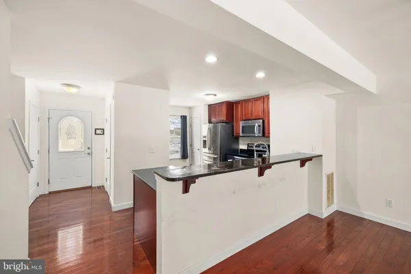 a view of living room with furniture and wooden floor