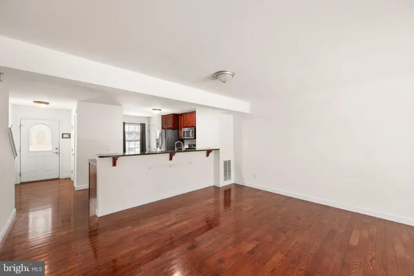 a view of a room with wooden floor and white walls