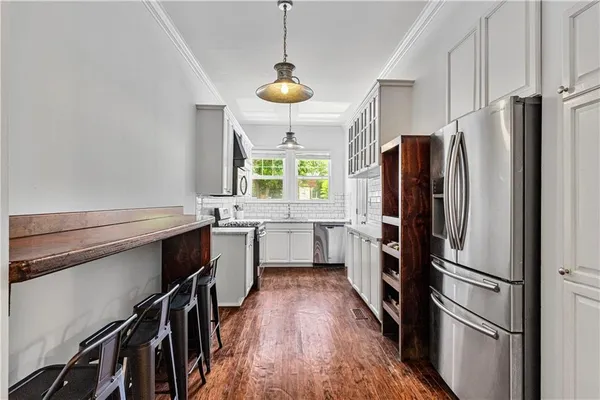 a kitchen with a refrigerator a sink and a stove