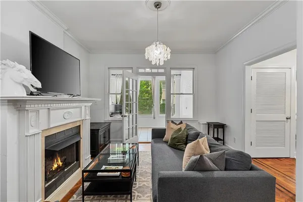 a living room with furniture a fireplace and a flat screen tv