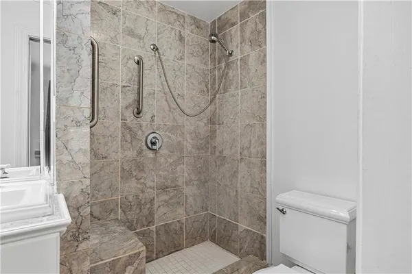 a bathroom with a toilet and a shower