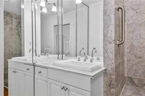 a bathroom with a double vanity sink and a mirror