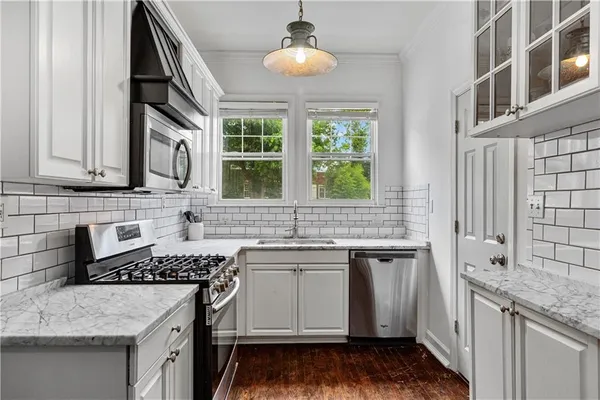 a kitchen with a sink stove and cabinets