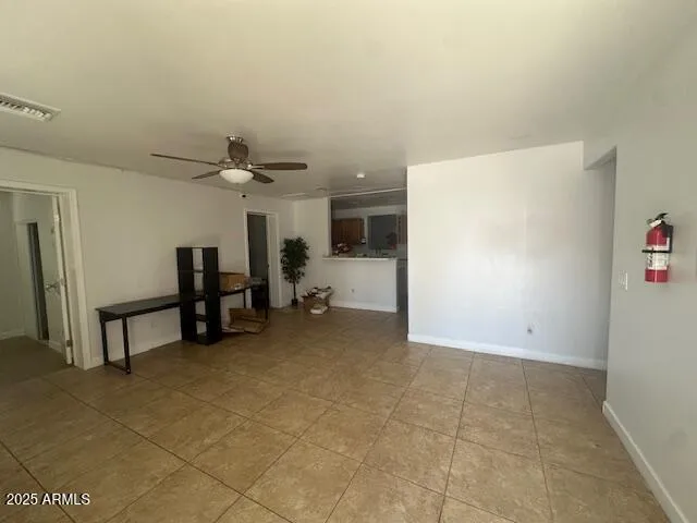 a view of a livingroom with furniture and a refrigerator