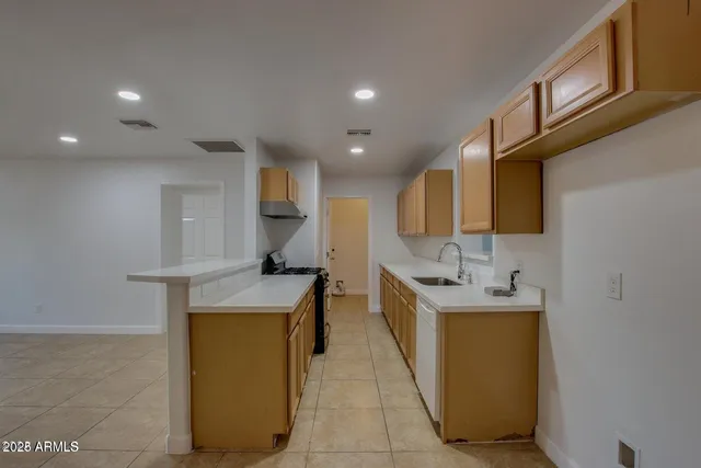 a kitchen with stainless steel appliances granite countertop a stove and a sink