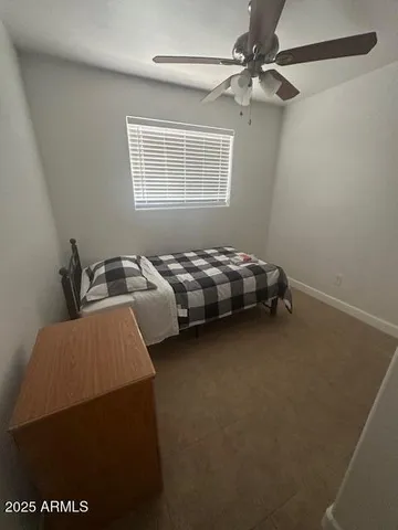 a bedroom with bed and window