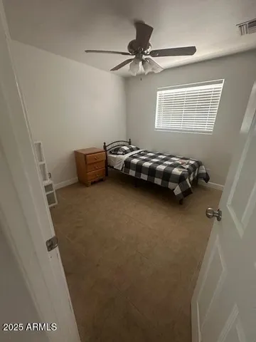 a view of a livingroom with a ceiling fan and a window
