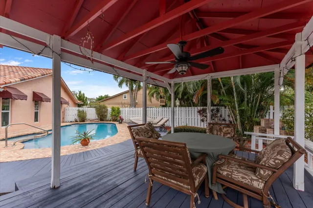 a view of a patio with table and chairs and wooden floor