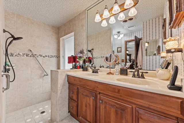 a bathroom with a bath tub a mirror and a shower