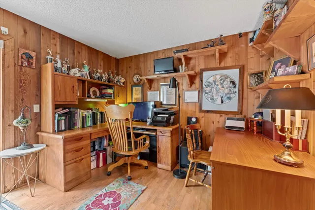a bedroom with a bed dresser and a large window
