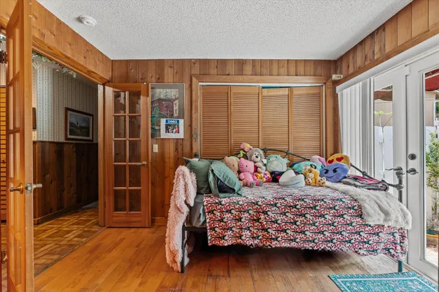 a view of a patio with table and chairs and floor to ceiling window and potted plants