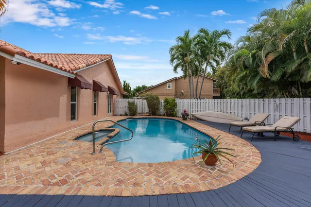 a view of a house with pool porch and chairs