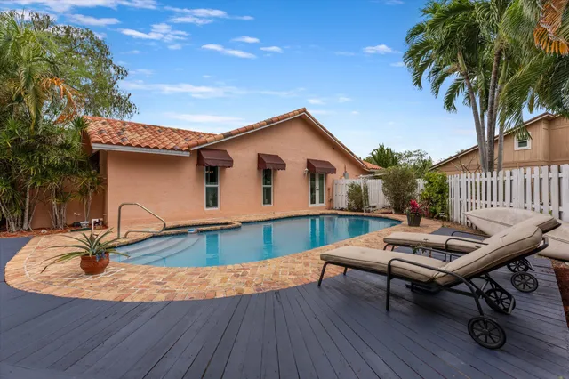a view of a patio with swimming pool table and chairs
