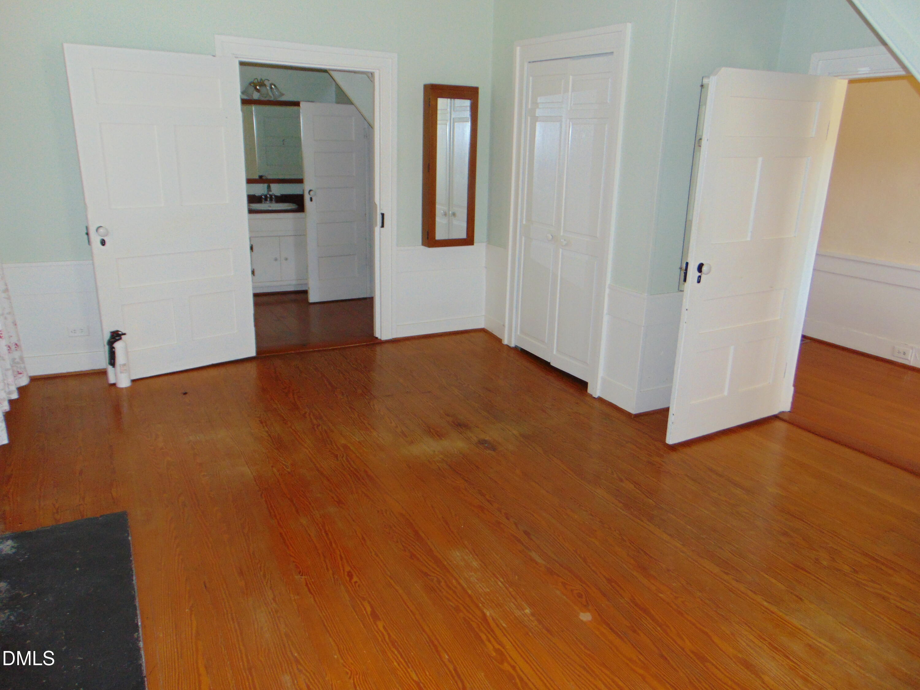 4067 Chewning Road Oxford, NC 27565 - Photo 66 of 82 a view of an empty room with closet and wooden floor