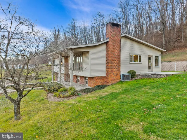 a view of staircase with lots of frames on wall and a large window