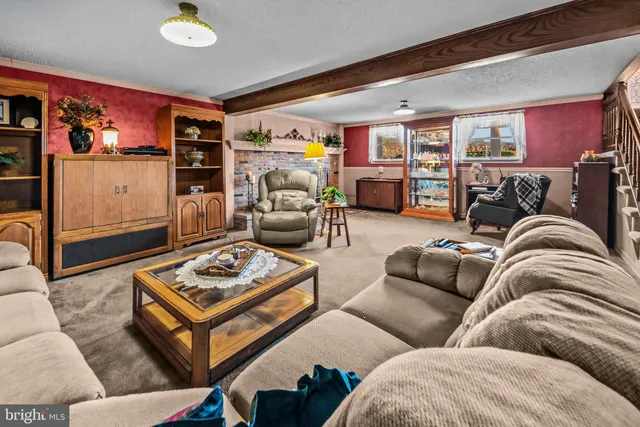 a kitchen with stainless steel appliances granite countertop a refrigerator a sink dishwasher a stove and white appliances with wooden floor