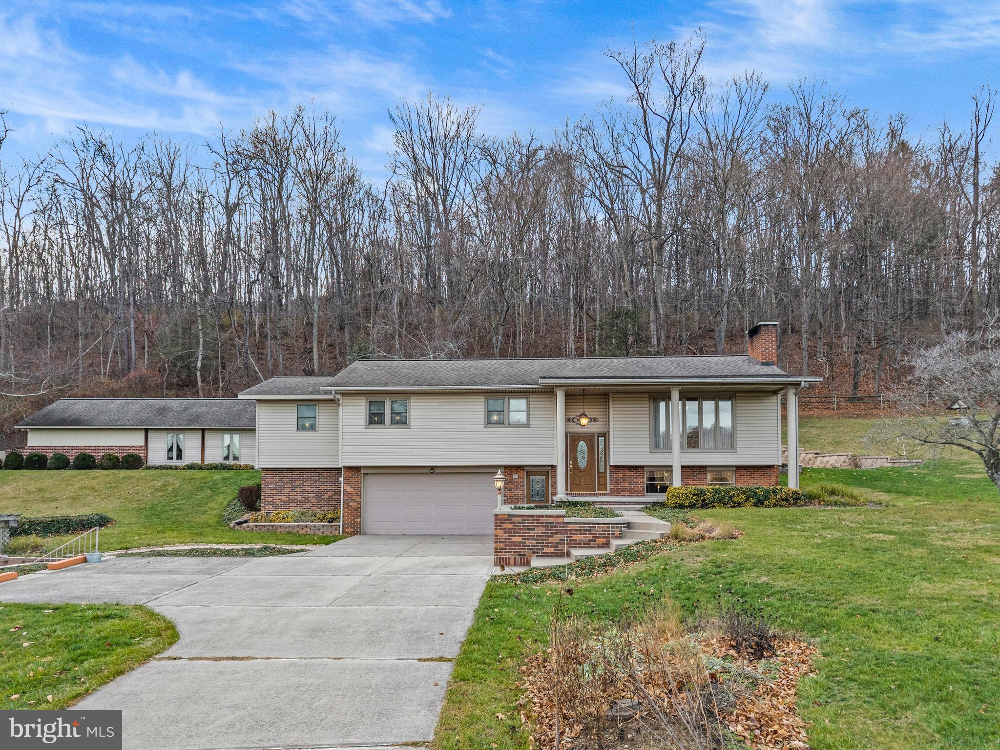 125 Housel Road Hopewell, PA 16650 - Photo 2 of 105 a front view of a house with a yard and trees