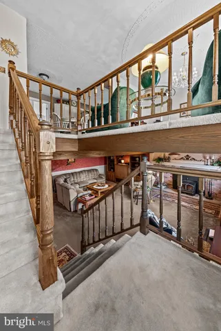 a living room with furniture a clock and a flat screen tv