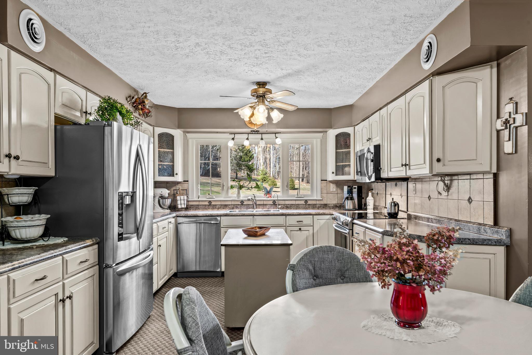 125 Housel Road Hopewell, PA 16650 - Photo 33 of 105 a kitchen with stainless steel appliances granite countertop a refrigerator sink and cabinets