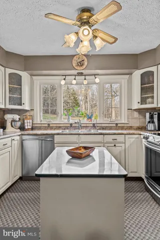 a spacious bathroom with a granite countertop sink a mirror and a shower