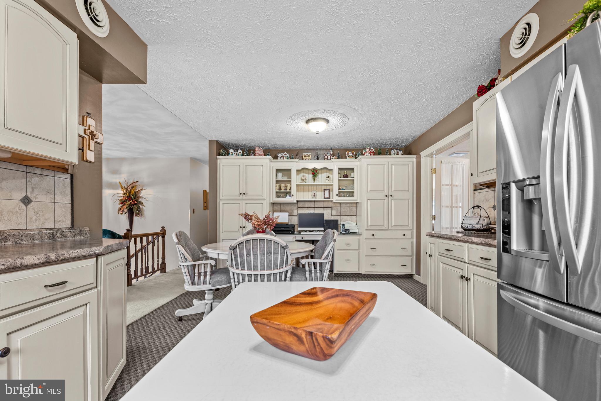 125 Housel Road Hopewell, PA 16650 - Photo 42 of 105 a kitchen with stainless steel appliances granite countertop a refrigerator a stove and a sink with cabinets