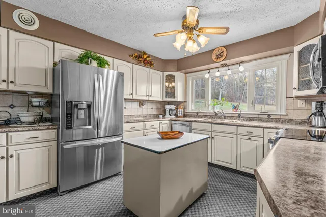 a view of a yard in front of a house with large trees