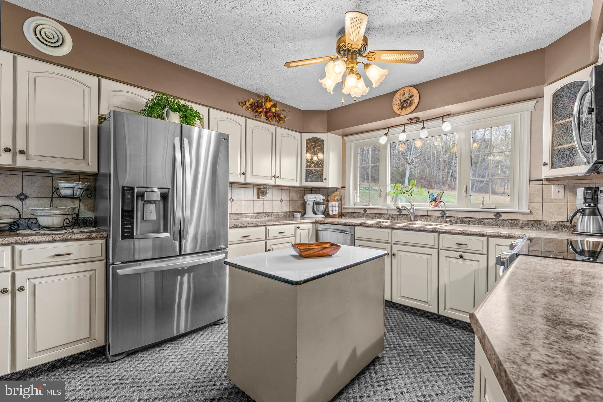 125 Housel Road Hopewell, PA 16650 - Photo 45 of 105 a kitchen with stainless steel appliances granite countertop a refrigerator a sink dishwasher a stove and white appliances with wooden floor