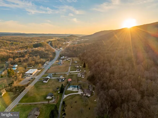 a kitchen with stainless steel appliances granite countertop a refrigerator and a stove