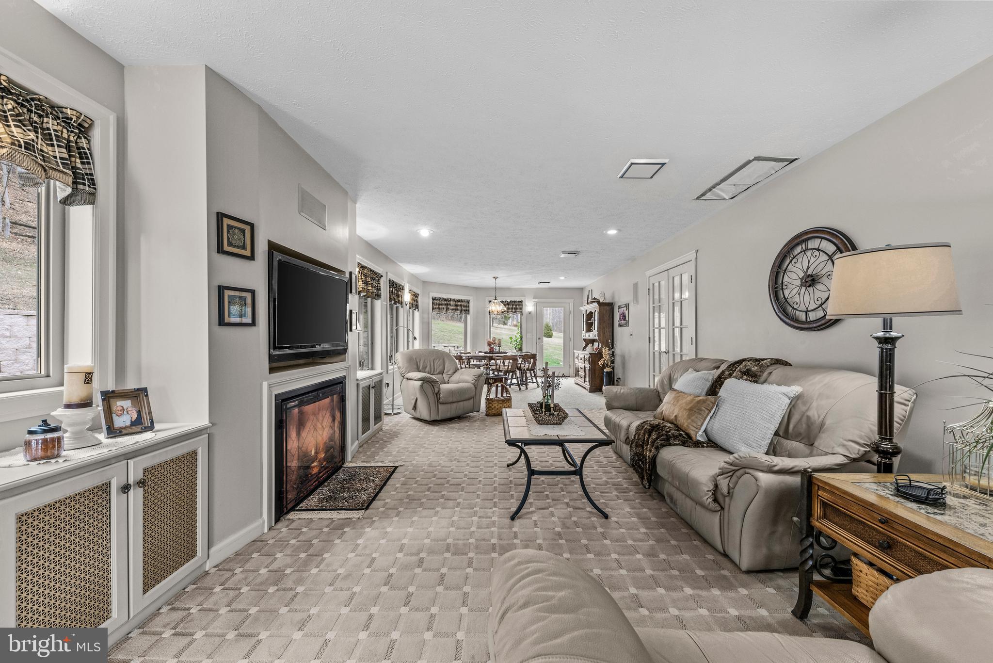 125 Housel Road Hopewell, PA 16650 - Photo 61 of 105 a living room with furniture a clock and a flat screen tv