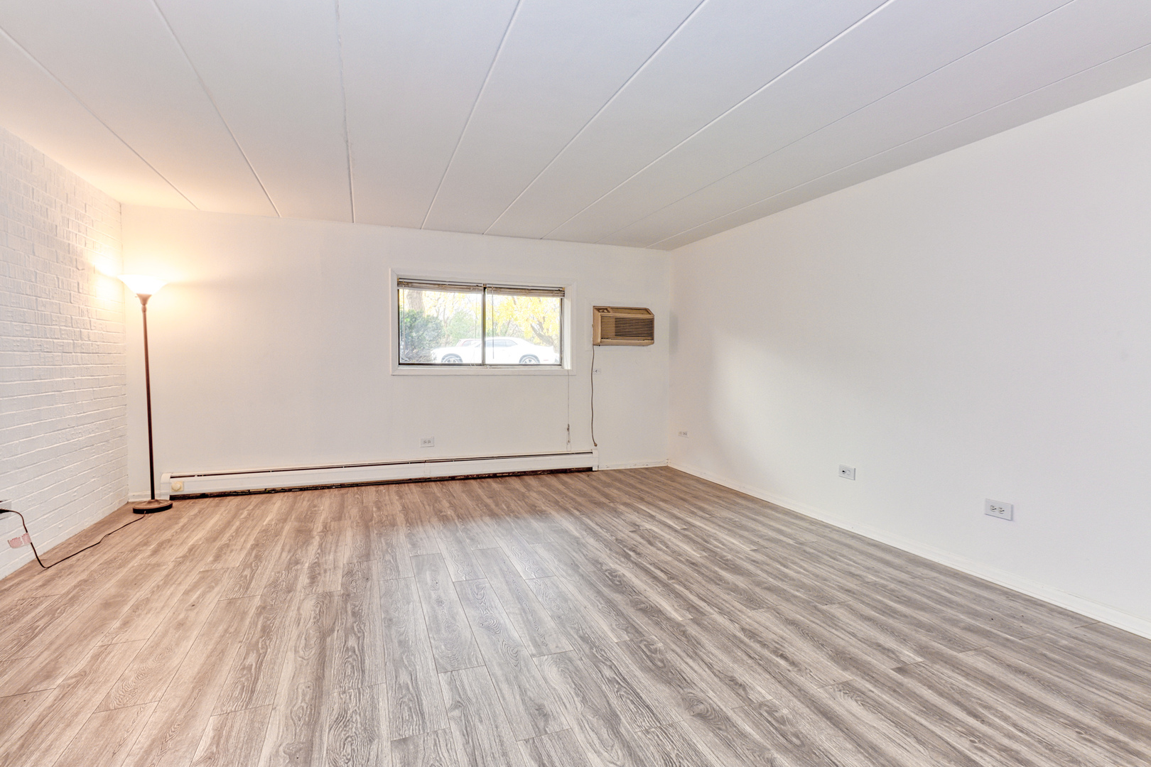 138 East Bailey Road, Unit B Naperville, IL 60565 - Photo 3 of 12 an empty room with wooden floor and windows
