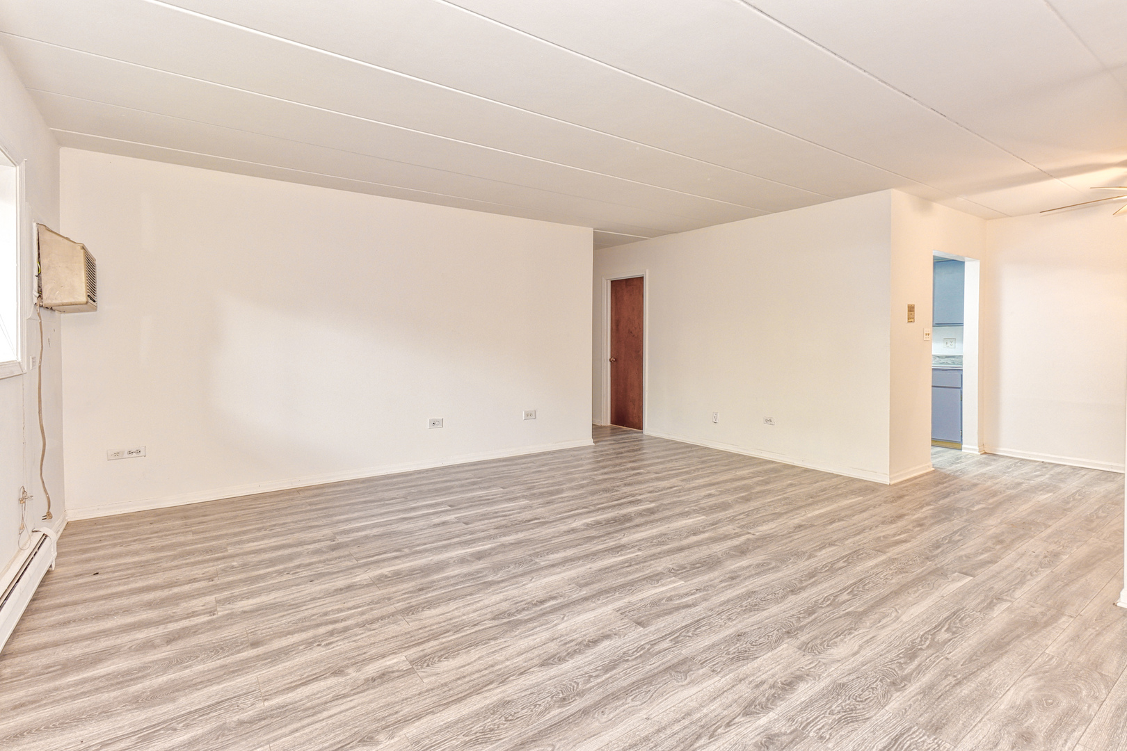 138 East Bailey Road, Unit B Naperville, IL 60565 - Photo 4 of 12 a view of empty room with wooden floor