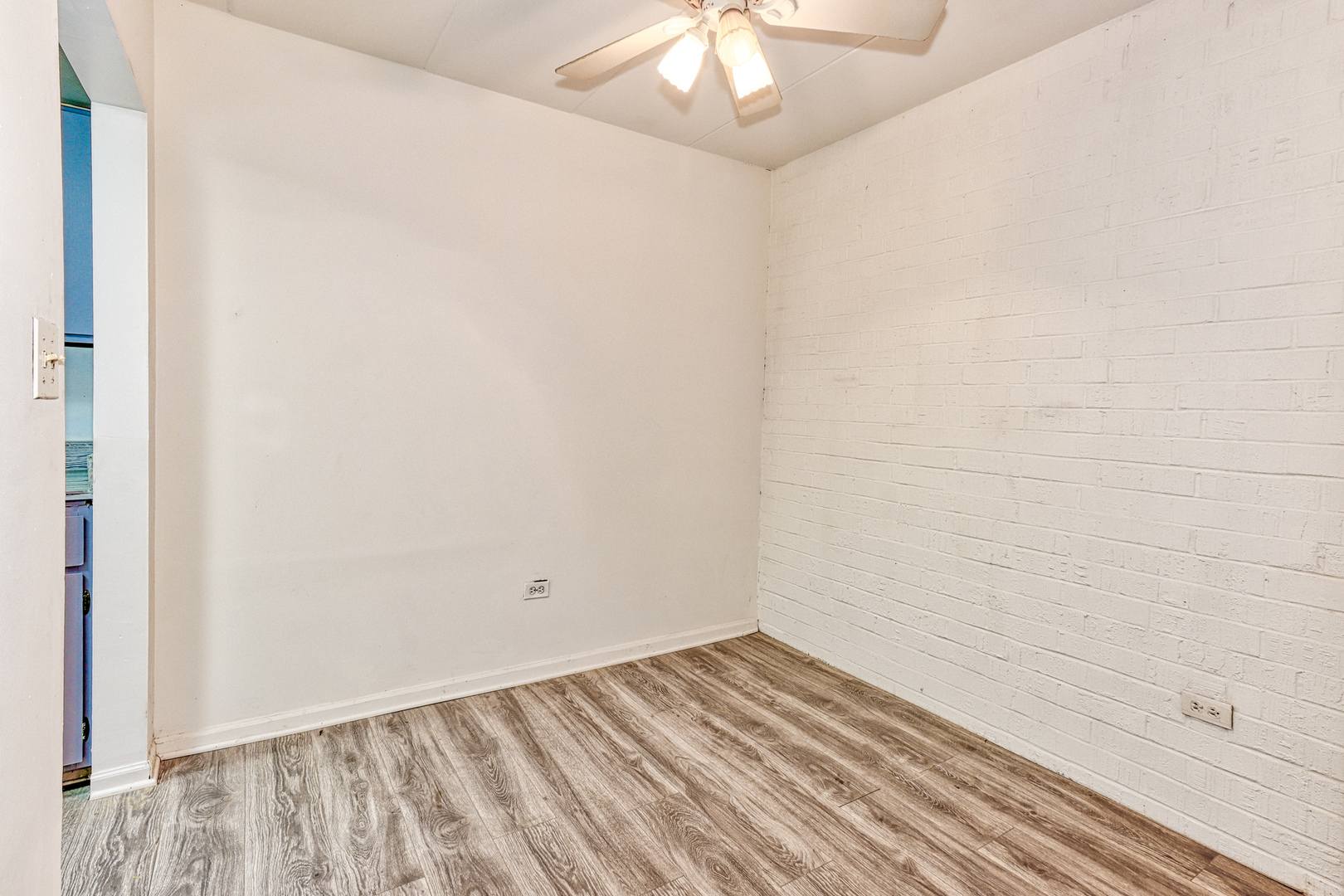 138 East Bailey Road, Unit B Naperville, IL 60565 - Photo 7 of 12 a view of a room with wooden floor and ceiling fan