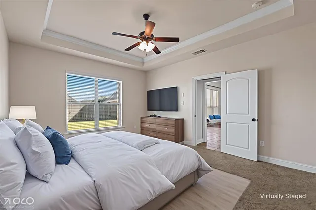 a bedroom with a large bed and a flat screen tv