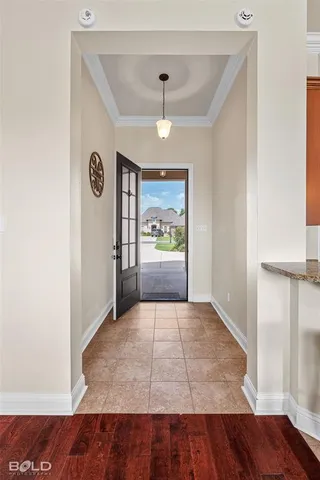 a view of hallway with wooden floor and window