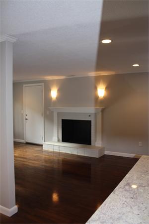 160 Parish Road Needham, MA 02494 - Photo 3 of 14 a view of an empty room with wooden floor and a fireplace