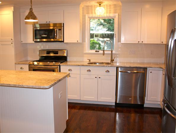 160 Parish Road Needham, MA 02494 - Photo 6 of 14 a kitchen with stainless steel appliances granite countertop a stove a sink and a microwave