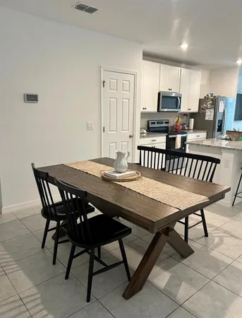 a kitchen with stainless steel appliances granite countertop a stove a sink a microwave and a refrigerator