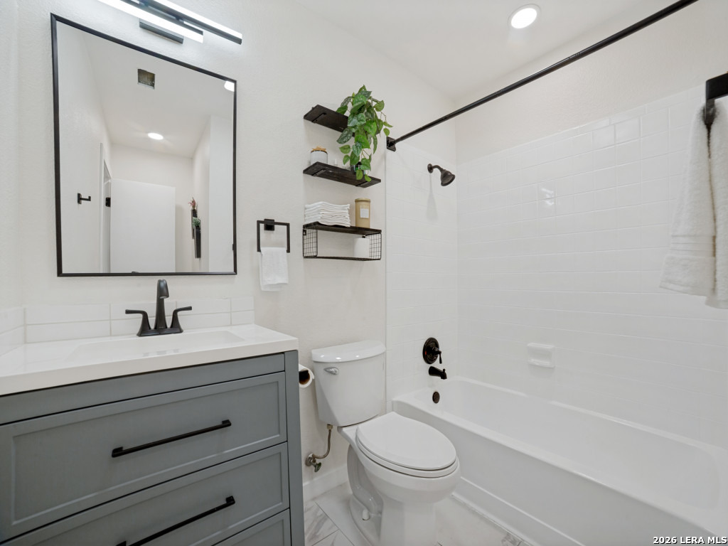 3439 Ridge Ranch San Antonio, TX 78247 - Photo 18 of 25 a bathroom with a sink a toilet and a mirror
