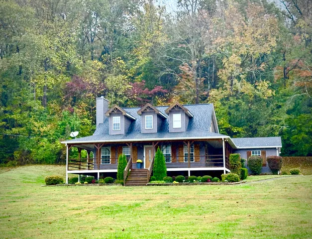 a view of a house with a yard and sitting area