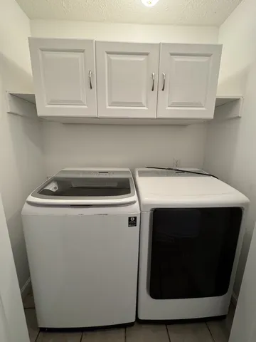 a view of a room with wooden floor and a sink