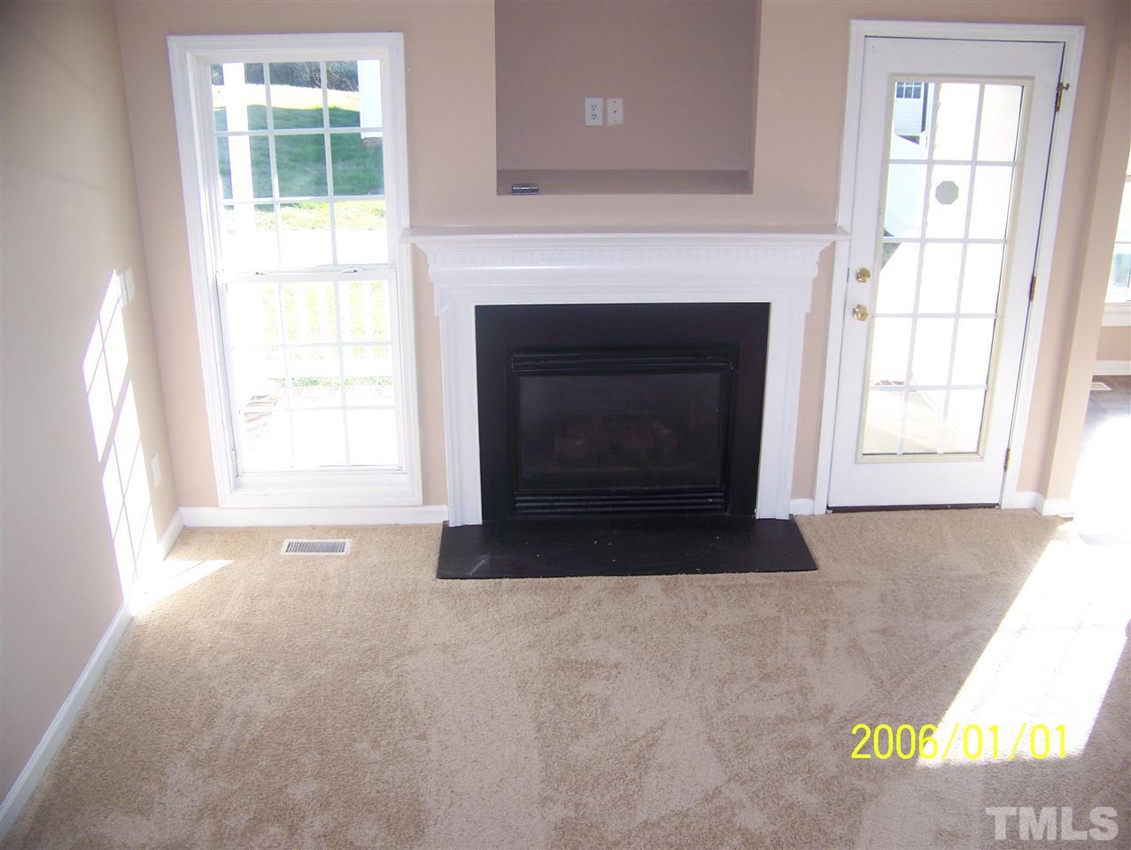 4244 Beacon Crest Way Raleigh, NC 27604 - Photo 3 of 6 an empty room with windows and fireplace