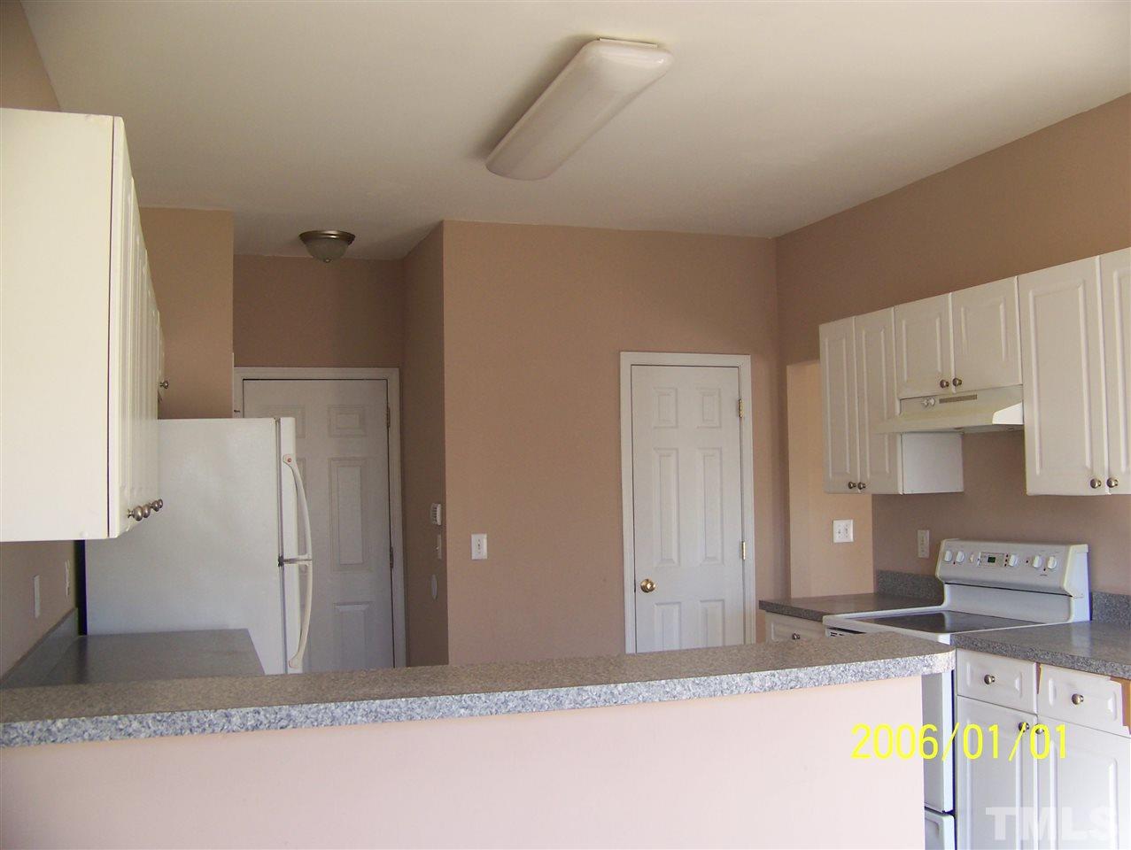 4244 Beacon Crest Way Raleigh, NC 27604 - Photo 5 of 6 a view of a kitchen with a sink and a refrigerator